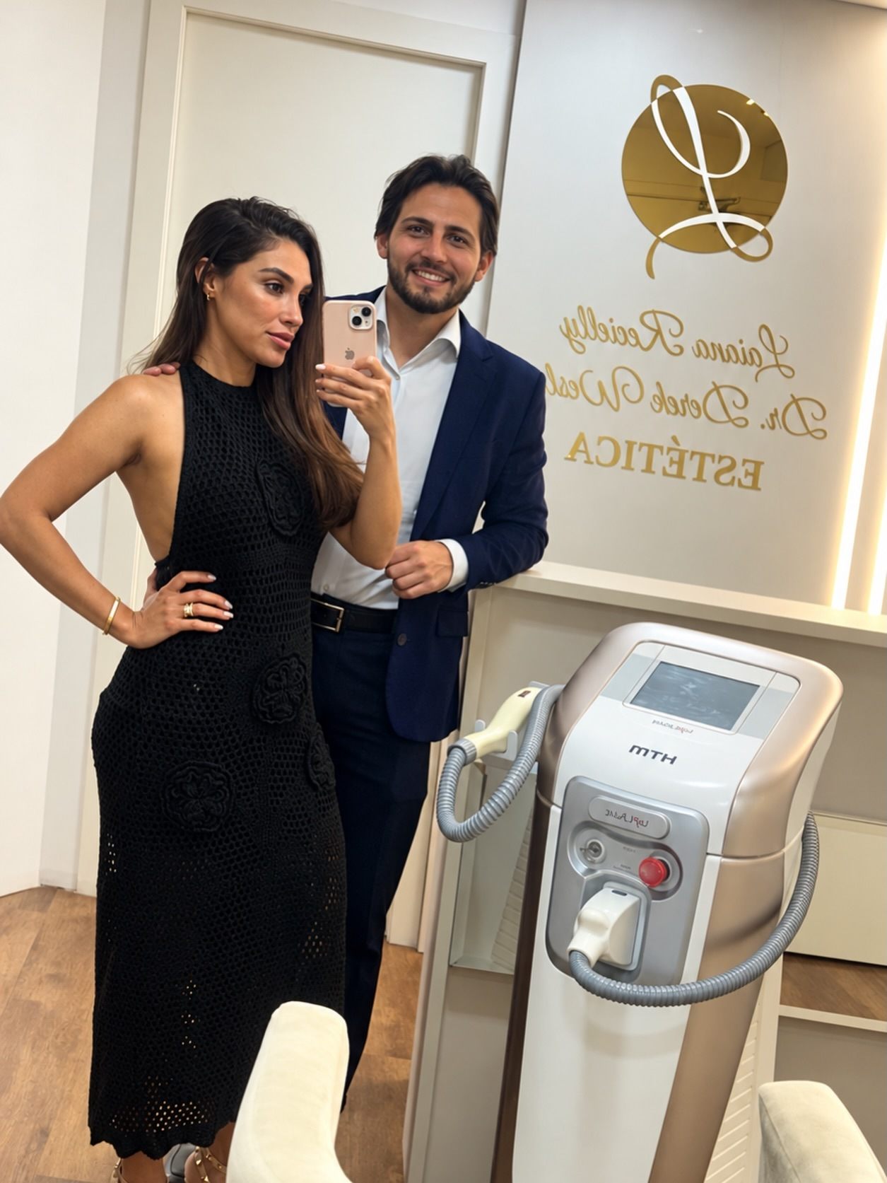 Laiana e Dr. Derek Wesley na recepção com o logo da clínica